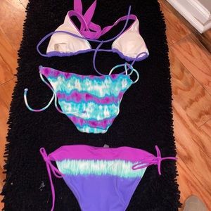 Women’s three piece bathing suit two bottoms a small one medium top Multi colors